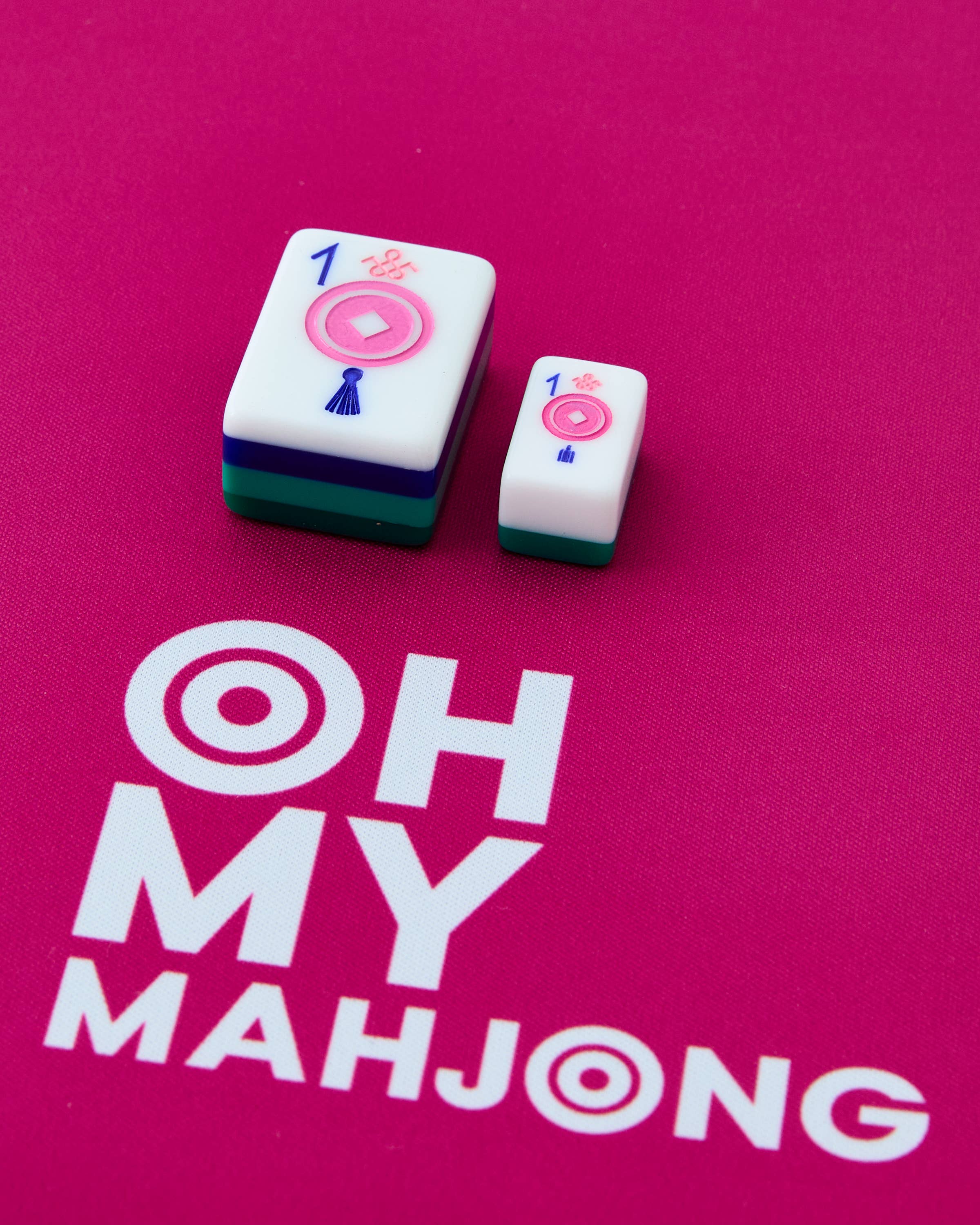 Two mahjong tiles on a pink background with 'OH MY MAHJONG' text.