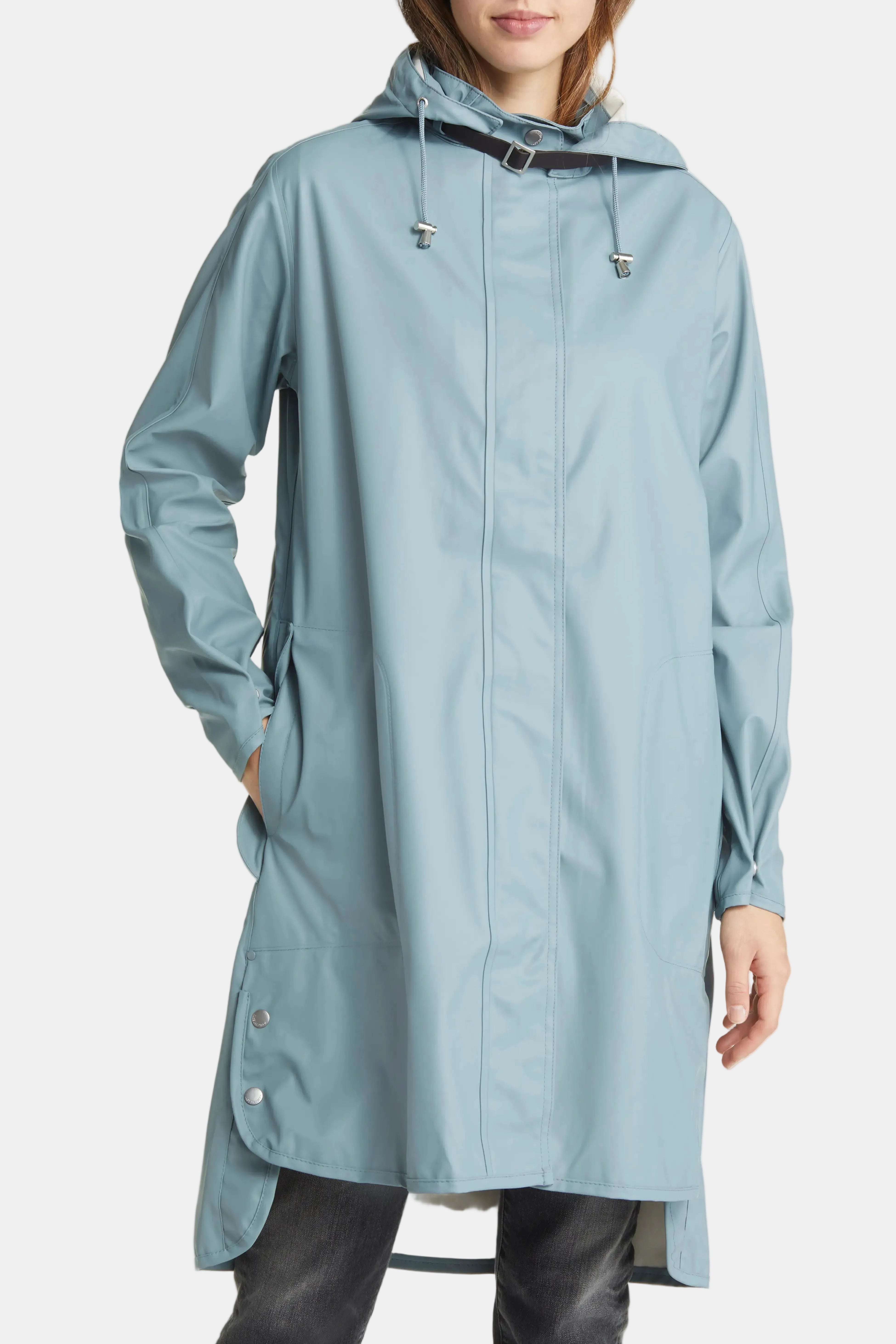 A woman wearing a light blue hooded raincoat with a front zipper, drawstrings, and side pockets, shown against a plain white background.