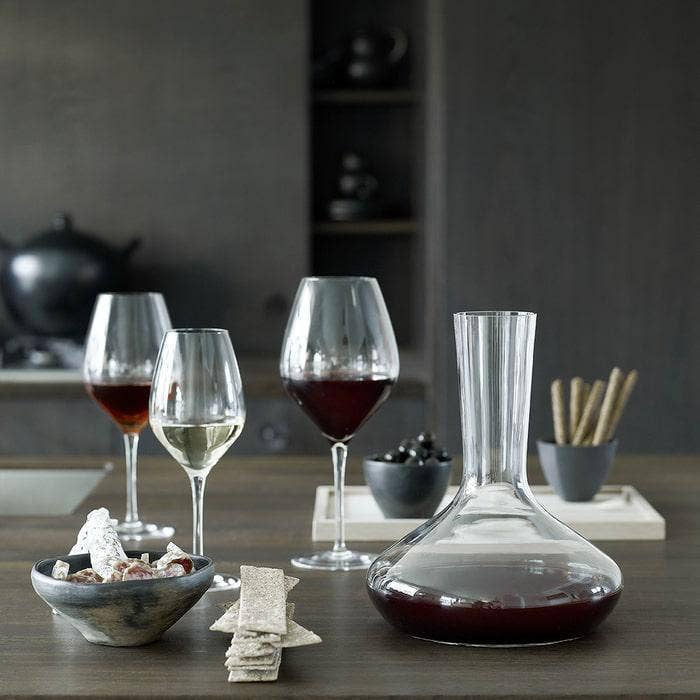 Wine glasses and decanter on a table with a dark background