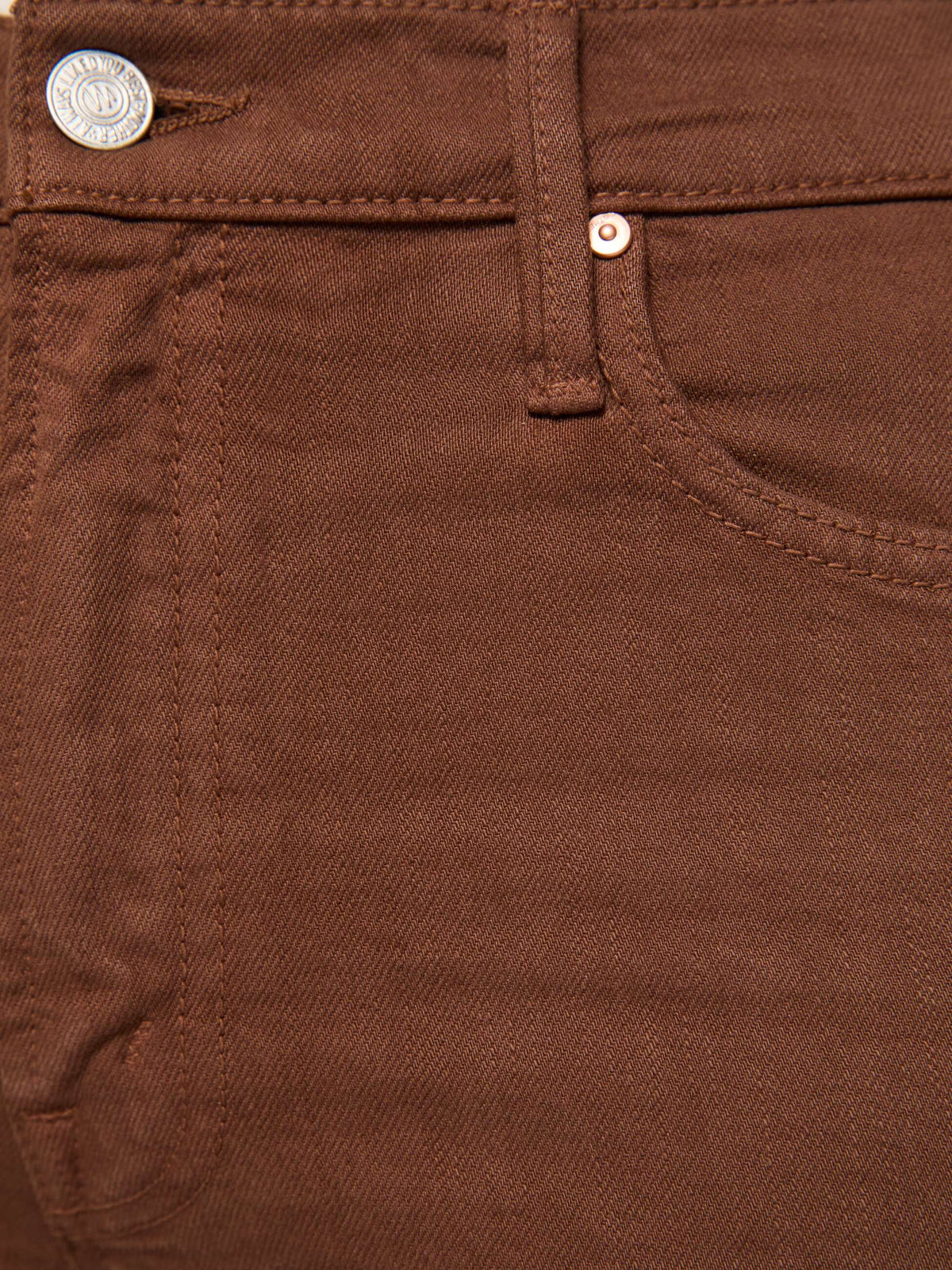 Close-up of brown pants with stitching details
