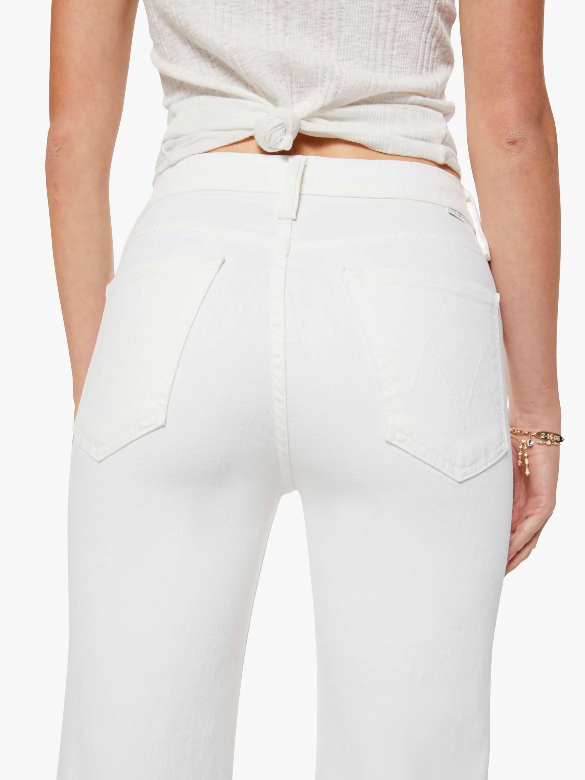 White pants worn by a person on a white background