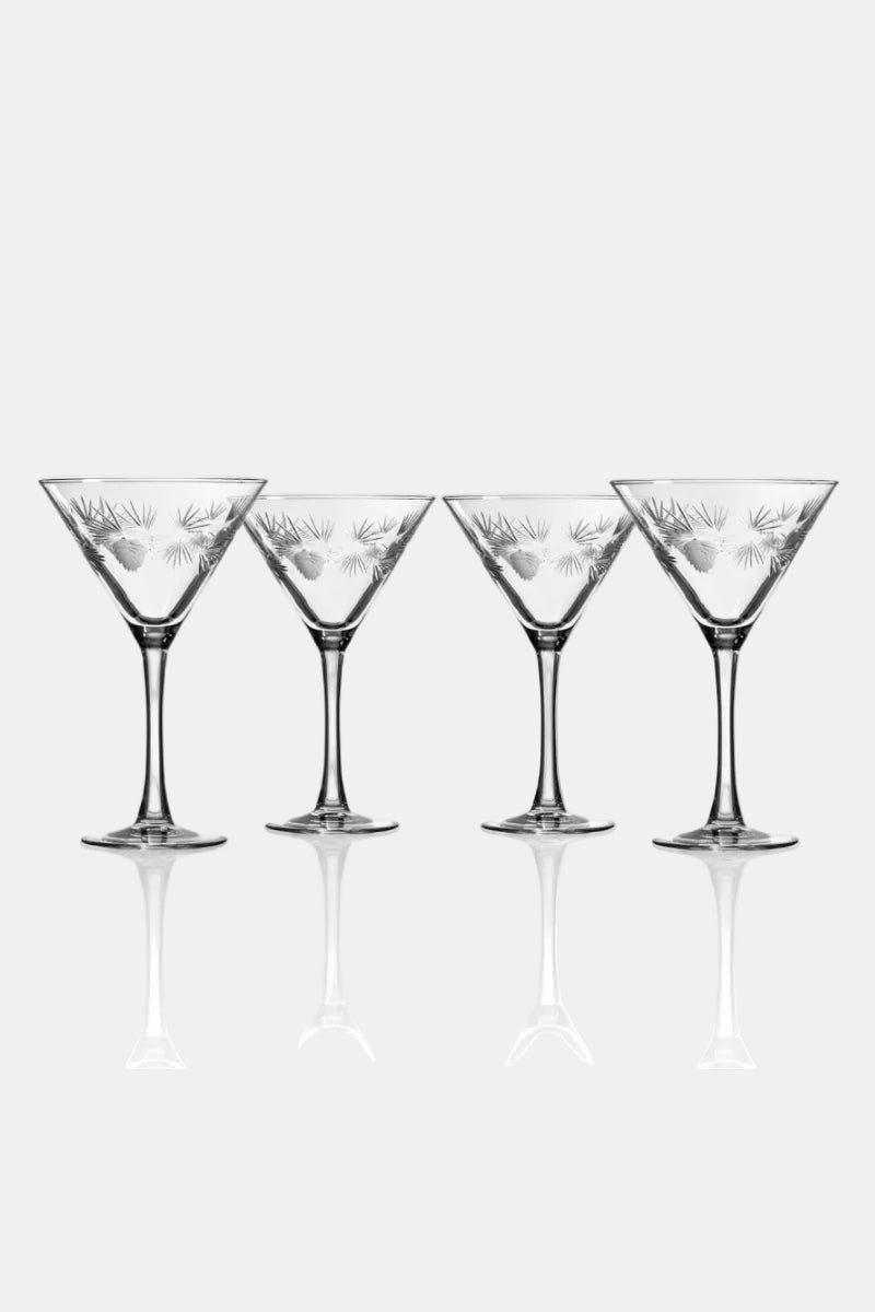 Four martini glasses with decorative etching on a white background