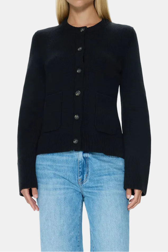 Woman wearing a black jacket and blue jeans on a white background