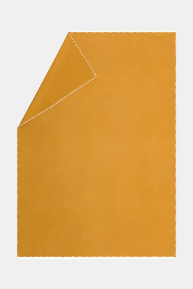 Mustard yellow envelope on a white background