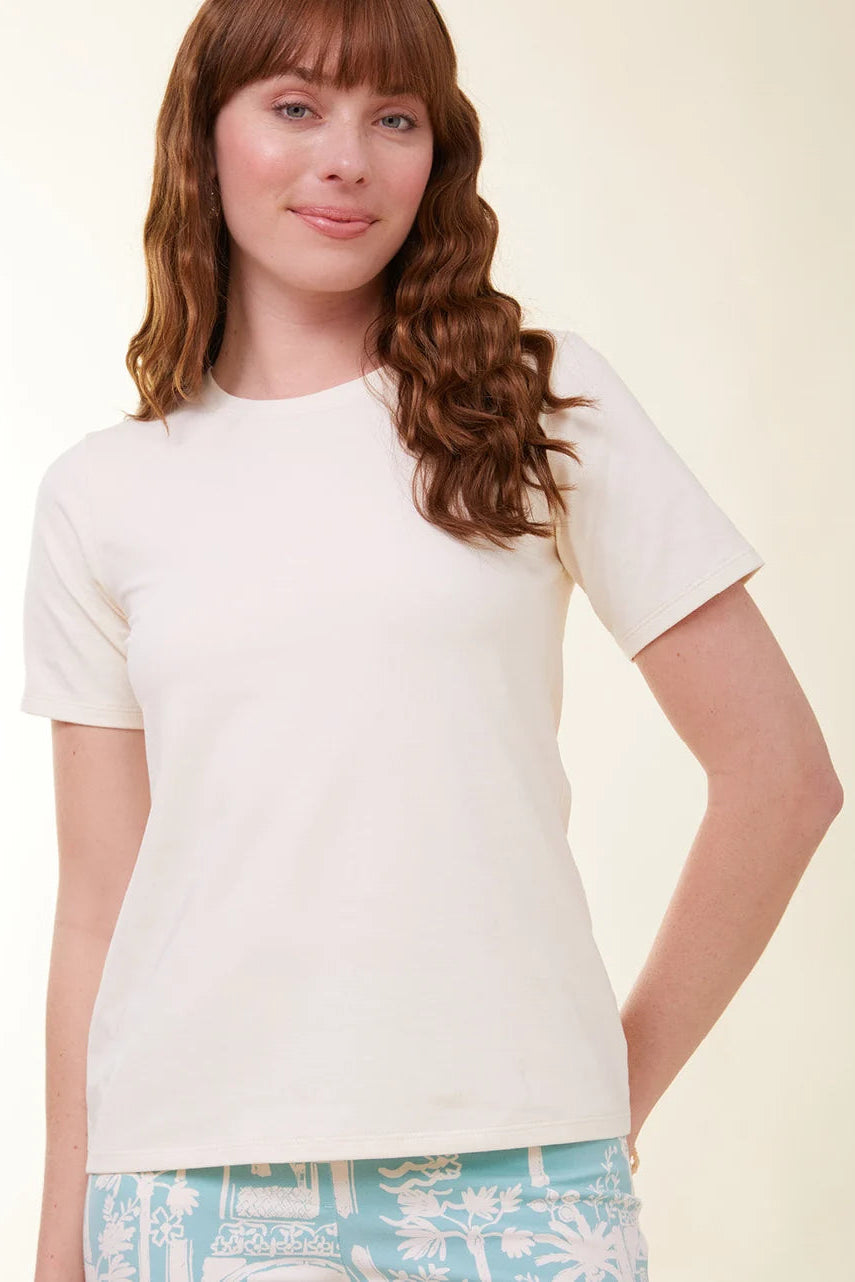 Woman wearing a plain white t-shirt against a light background