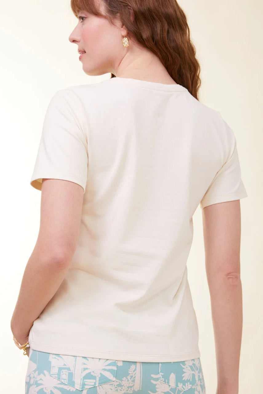 Woman wearing a white top with a light background