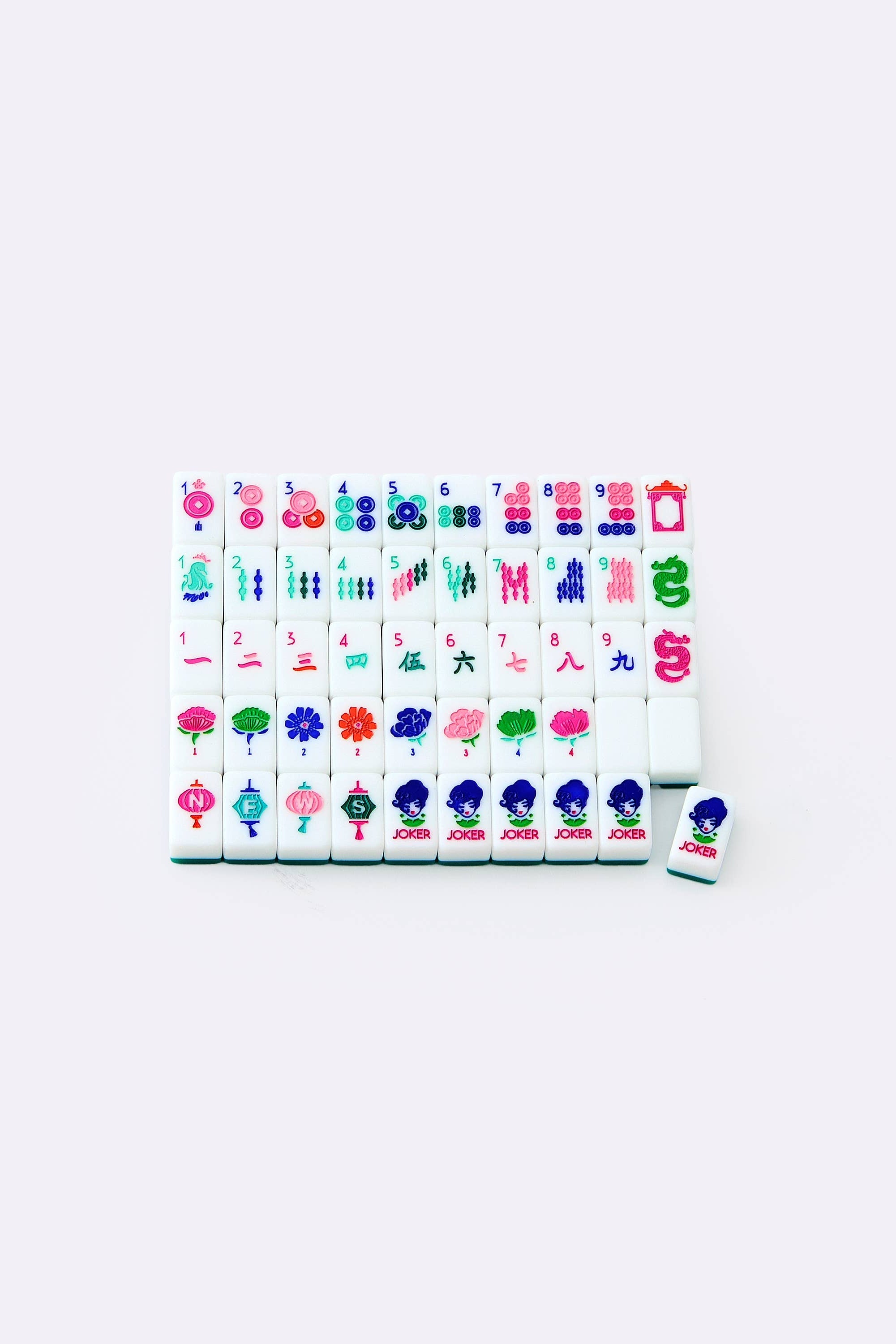 Set of colorful game pieces with symbols on a white background