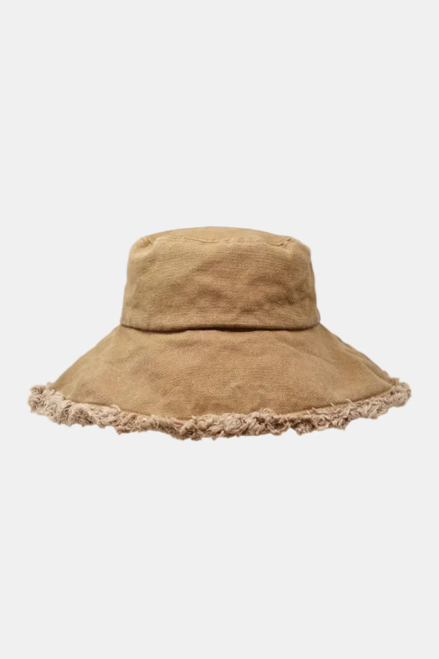 Beige bucket hat with frayed edge on a white background