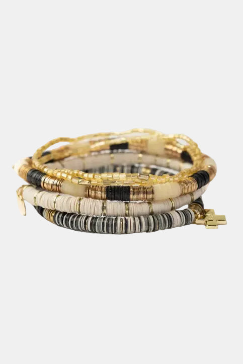 Set of beaded bracelets with gold accents on a white background