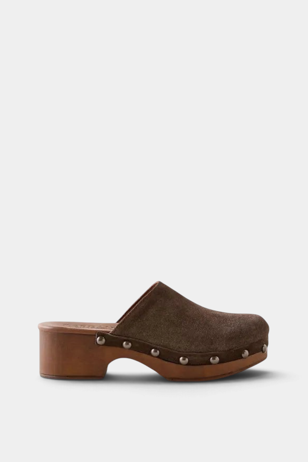 A single dark brown clog shoe with a suede upper, a wooden block heel, and silver metal studs, shown in a side profile on a light cream background.