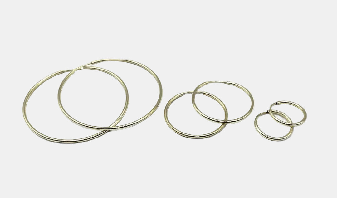 Set of gold hoop earrings on a white background