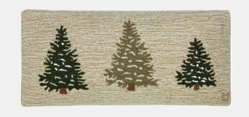Rectangular rug with three stylized pine trees on a beige background