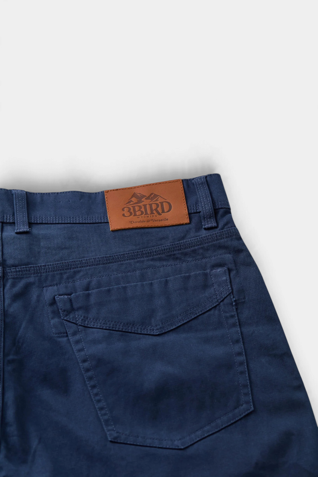 The Copper Shed Breakout broken twill pants in navy blue with a leather brand patch and reinforced back pocket.