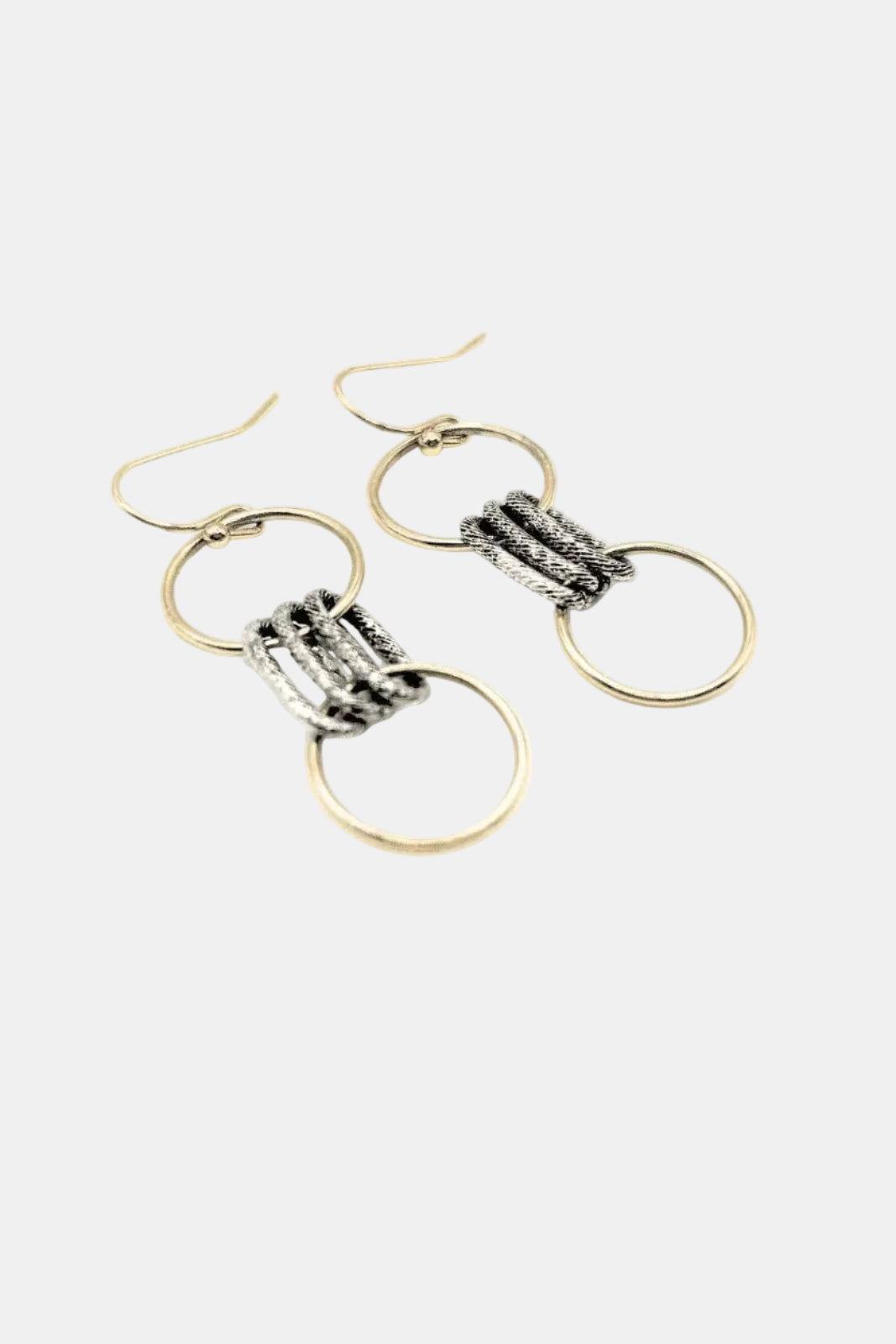 Gold and silver earrings on a white background