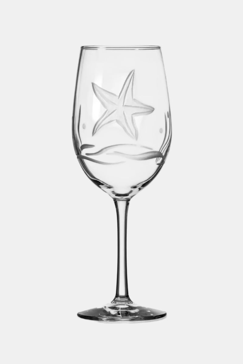 Clear wine glass with a starfish design on a white background