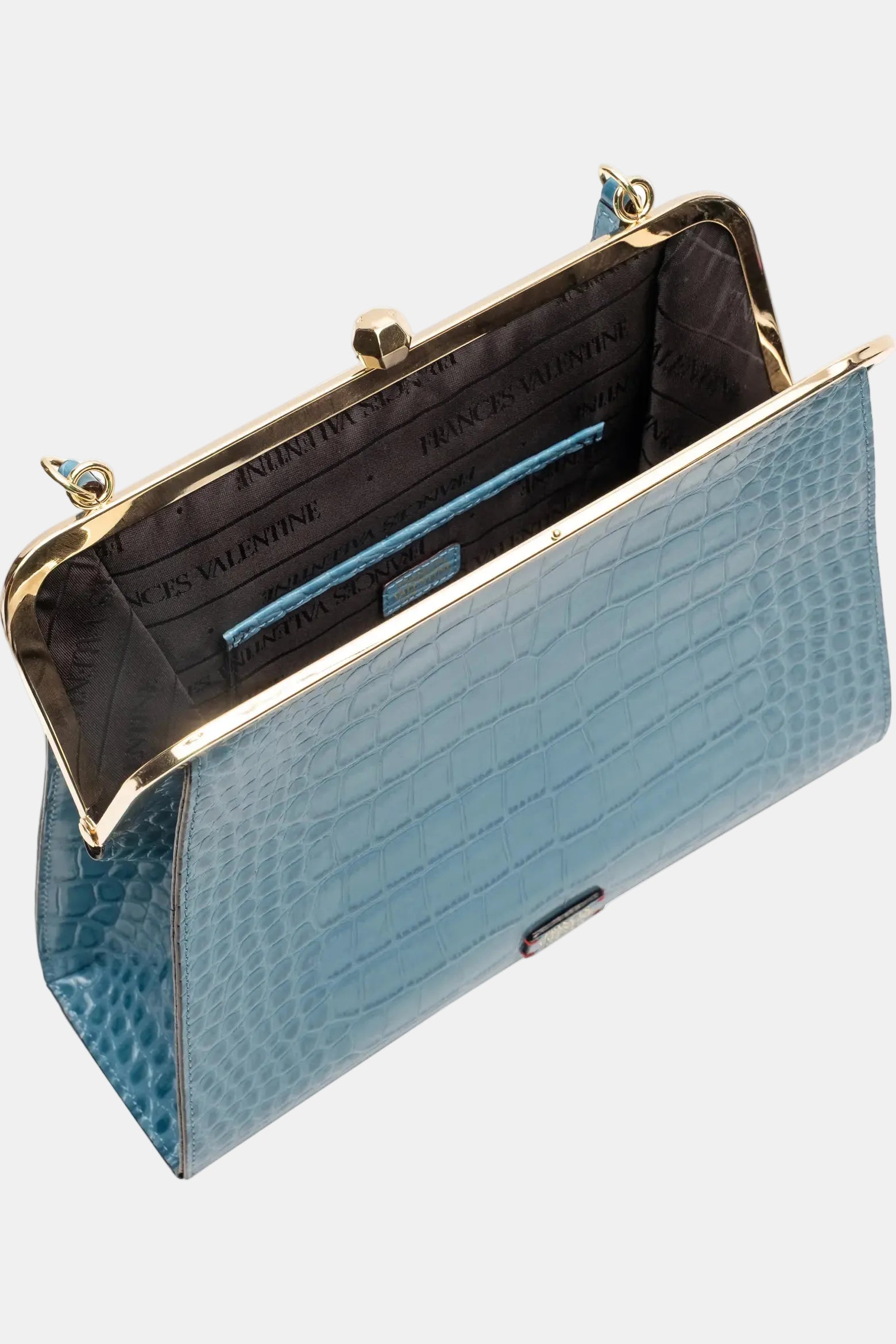 A light blue crocodile-embossed clutch purse shown open, displaying its gold-tone metal frame, interior card slots, and branded interior lining that reads 'PRINCE VALDINI'.