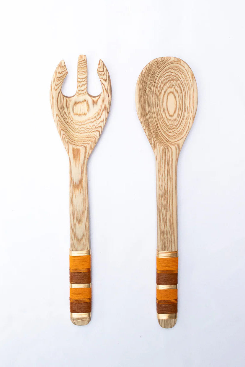 Wooden spoon and fork set with decorative handles on a white background