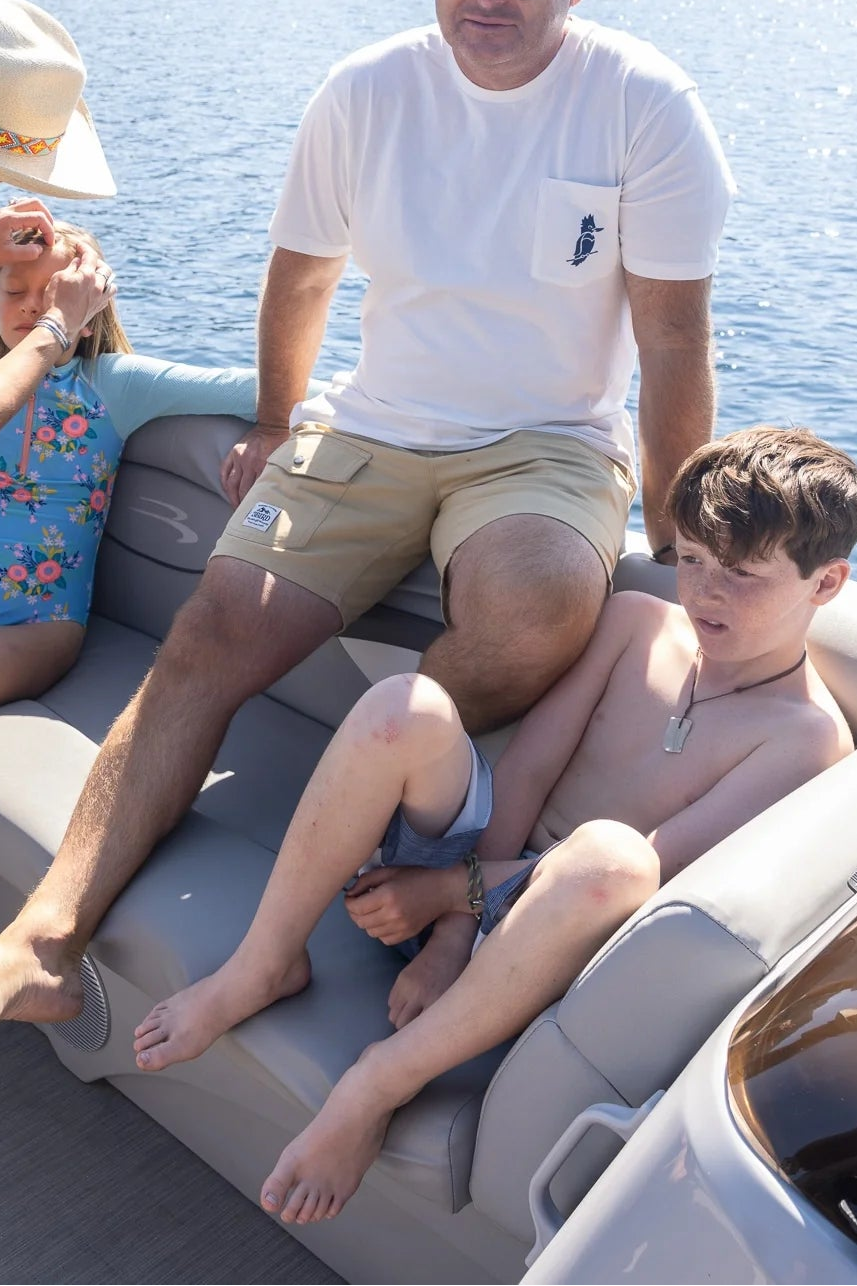 Family on a boat in a lake with mountains in the background