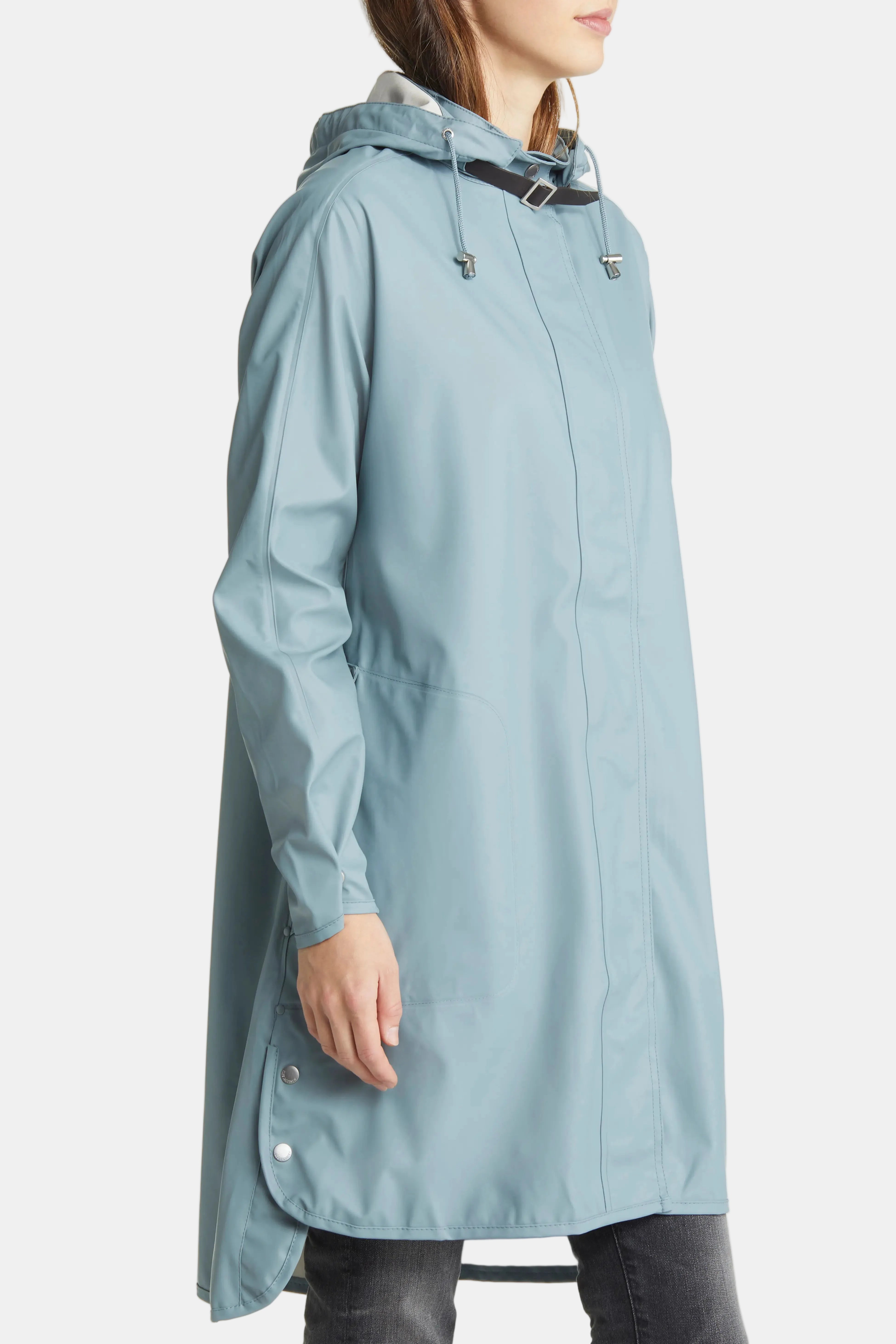 A woman wearing a light blue hooded raincoat, shown from the side against a plain white background.