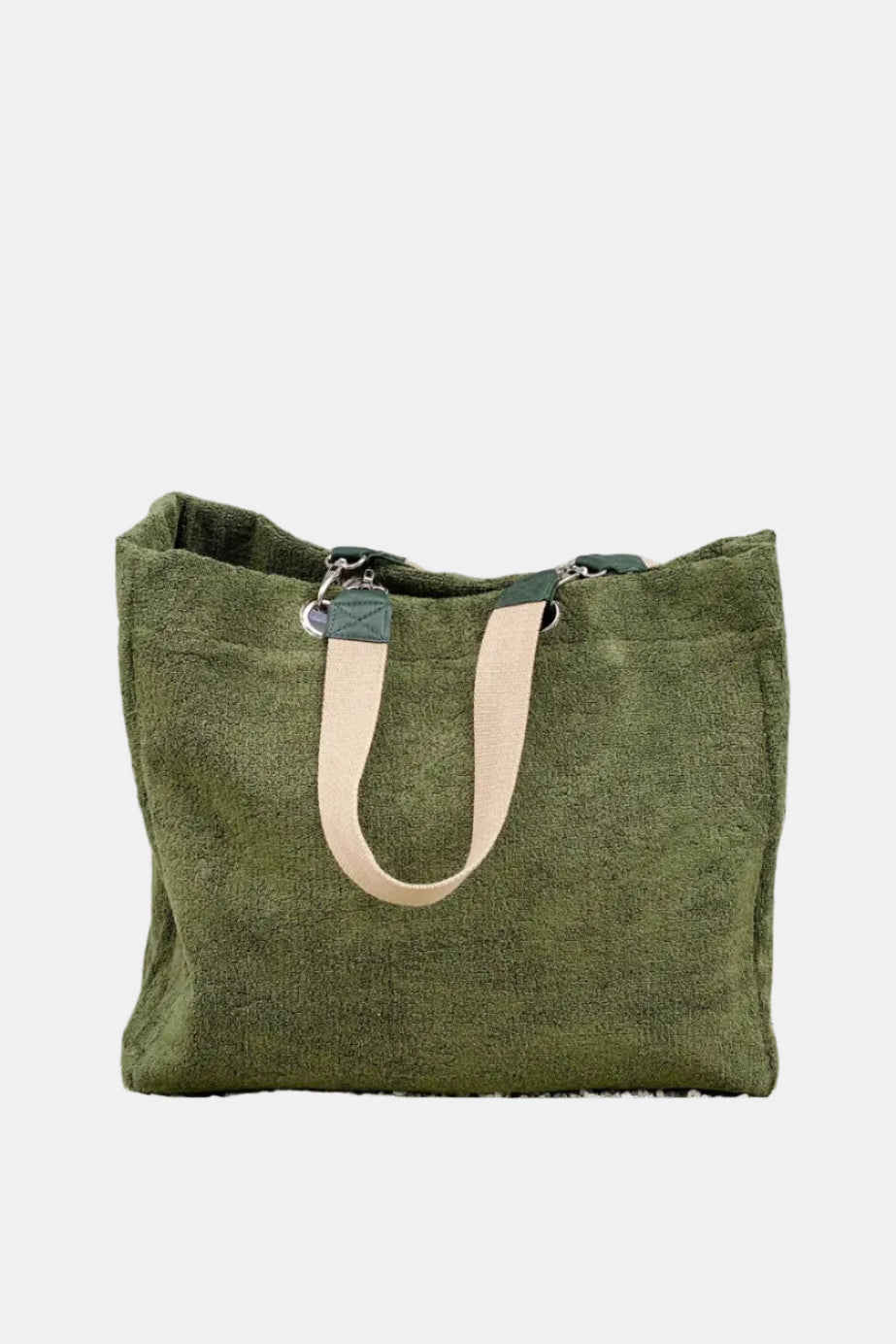 Green tote bag with beige handles against a textured wall.