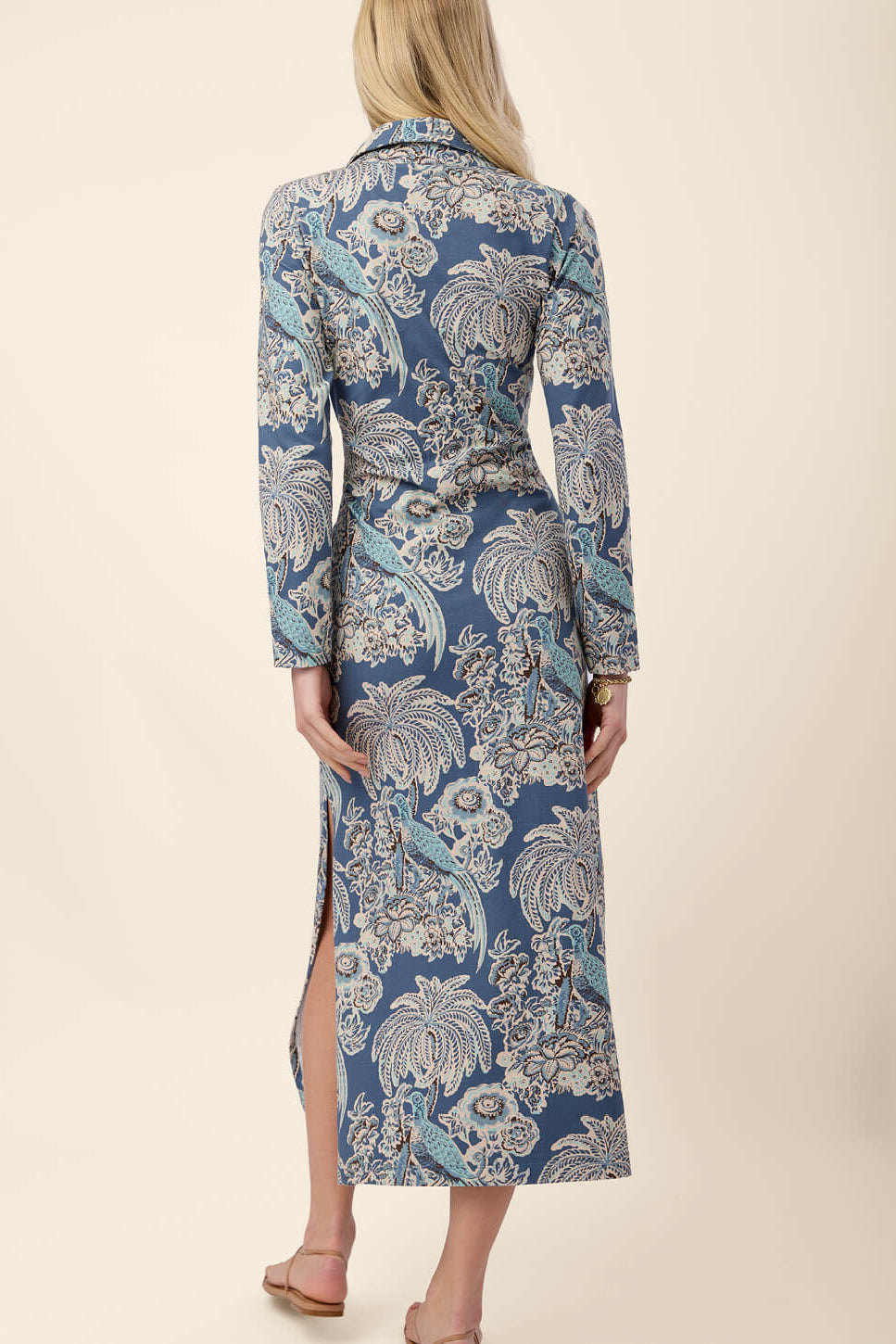 Woman wearing a blue floral dress with a beige background