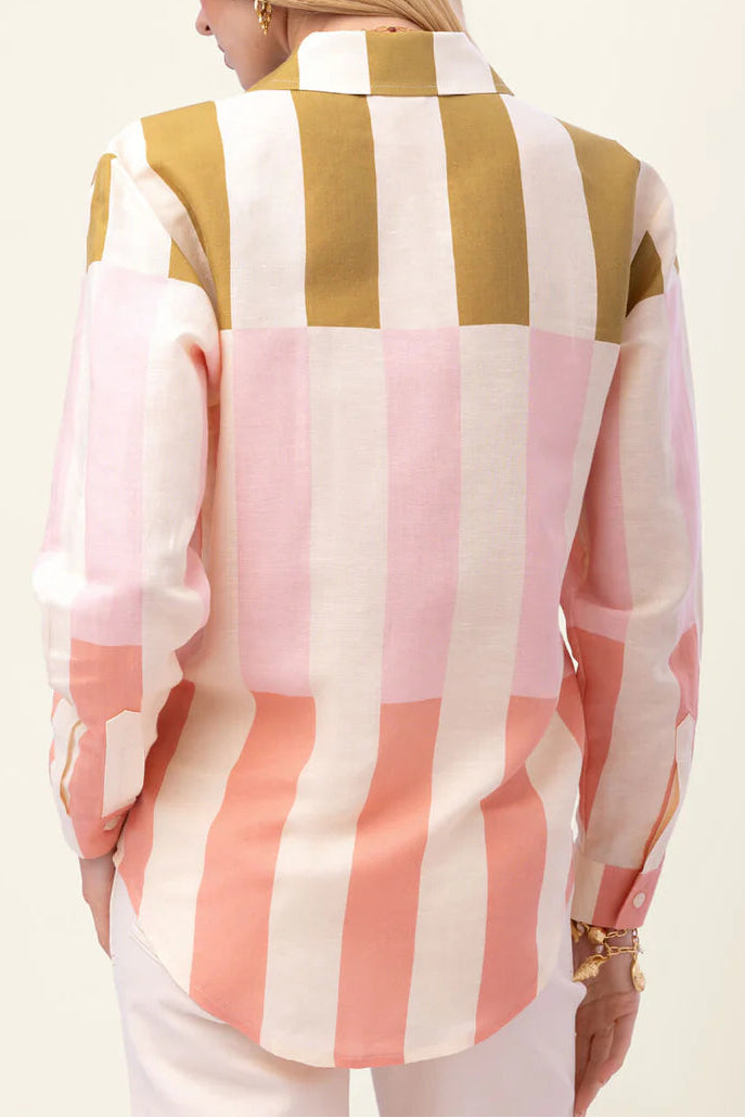 Woman wearing a colorful striped shirt with a white background