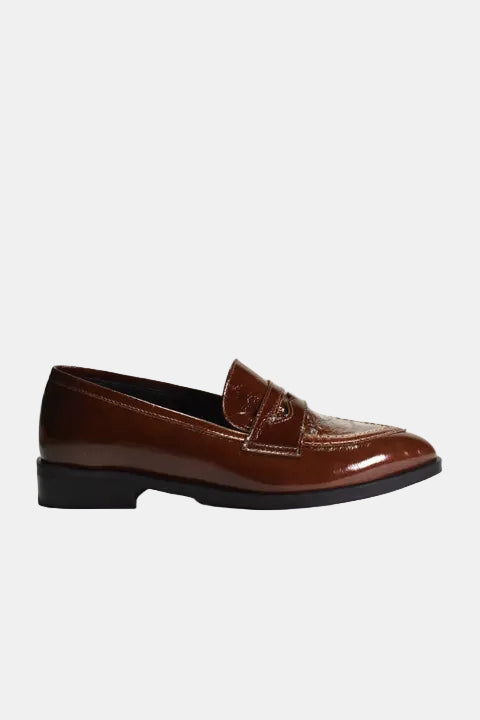 A single brown patent leather penny loafer with a pointed toe and black sole, shown in profile against a white background.