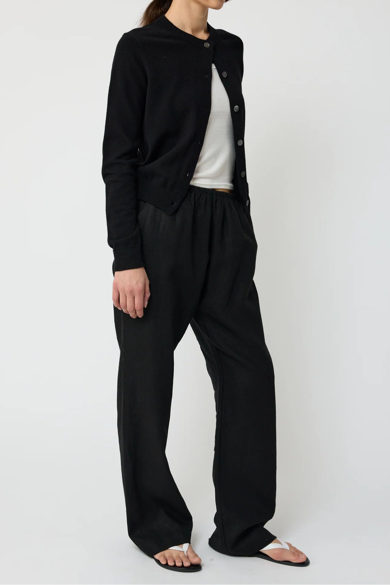 Person wearing a black outfit with a white background