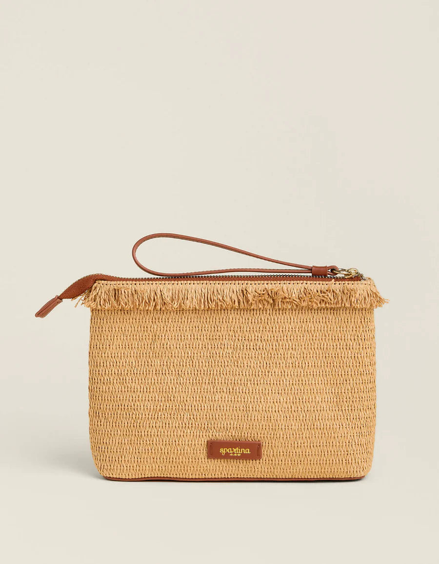 Woven clutch bag with brown handle and trim on a beige background