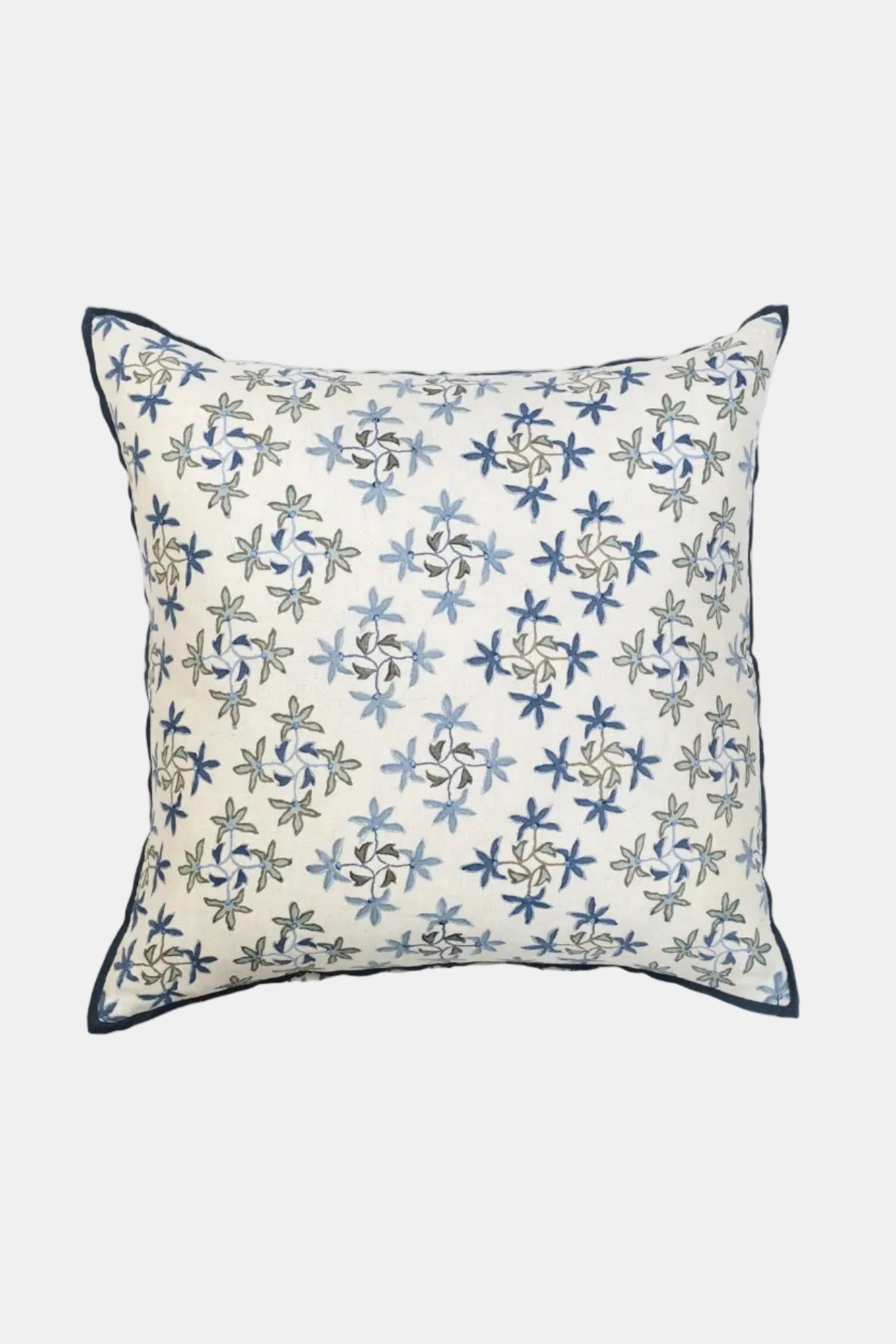 Decorative pillow with blue floral pattern on a beige background