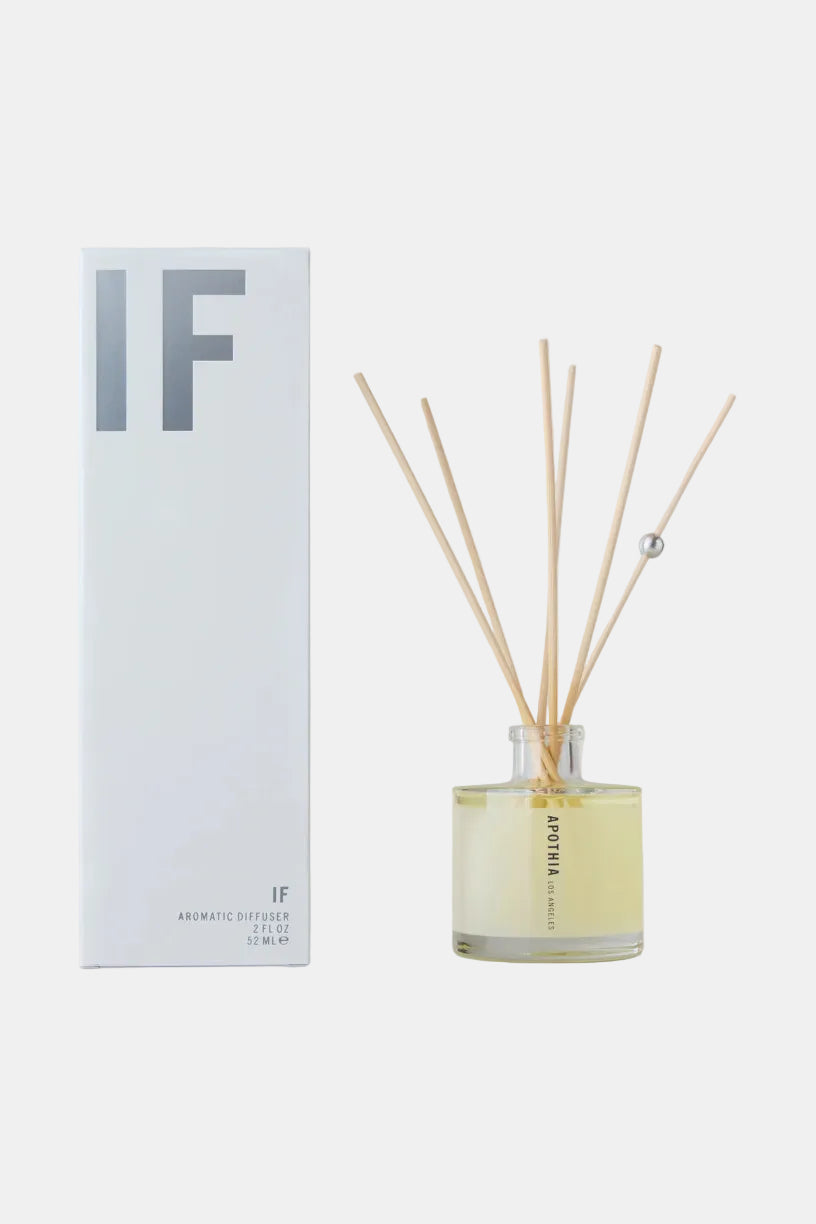 Aromatherapy diffuser with wooden sticks and a white box labeled 'IF' on a light gray background.