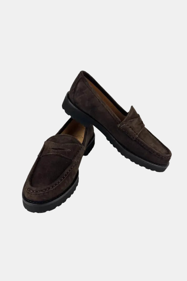 A pair of dark brown suede penny loafers with black soles, displayed on a clean white background.