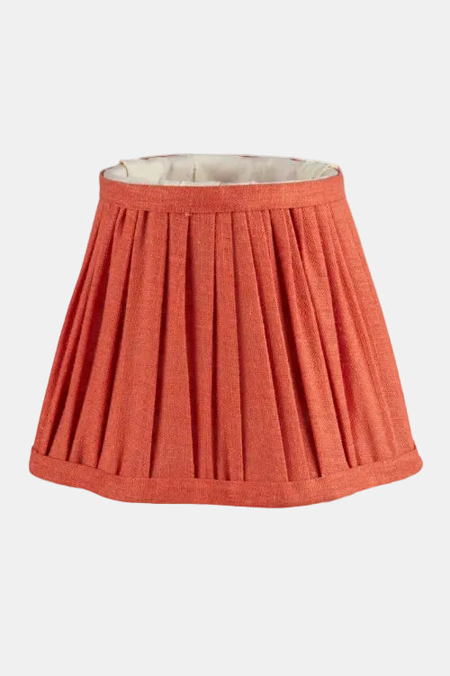 Red pleated lampshade on a white background