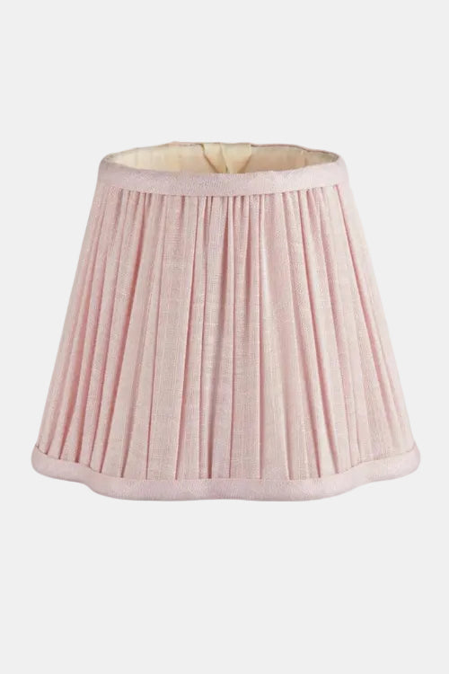 Pink pleated lampshade on a white background