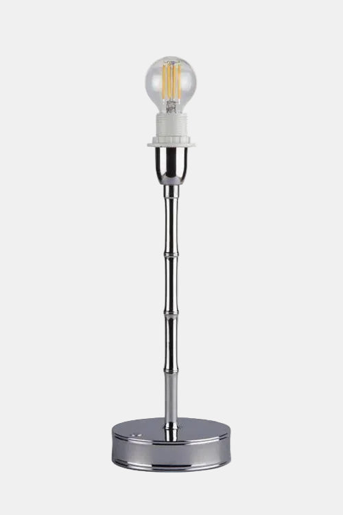 Chrome table lamp with a clear glass shade on a white background