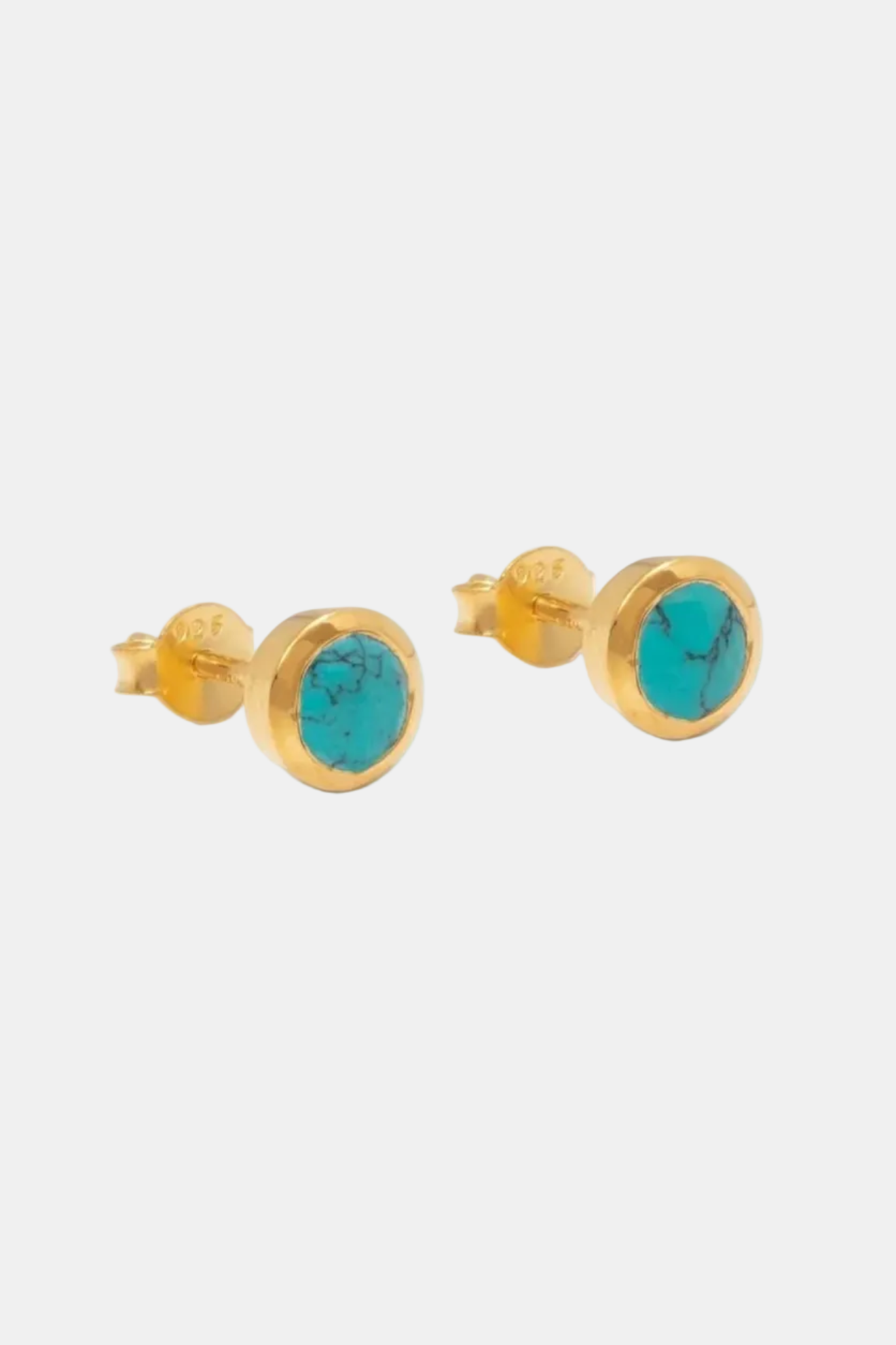 Gold earrings with turquoise stones on a white background