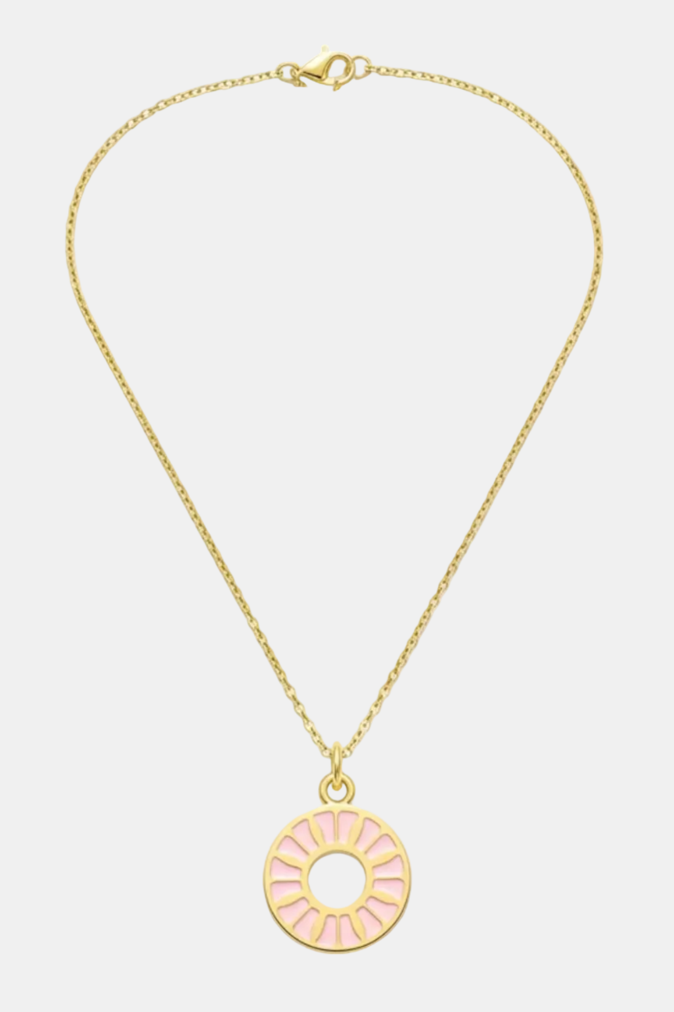 Gold necklace with a pink circular pendant on a white background