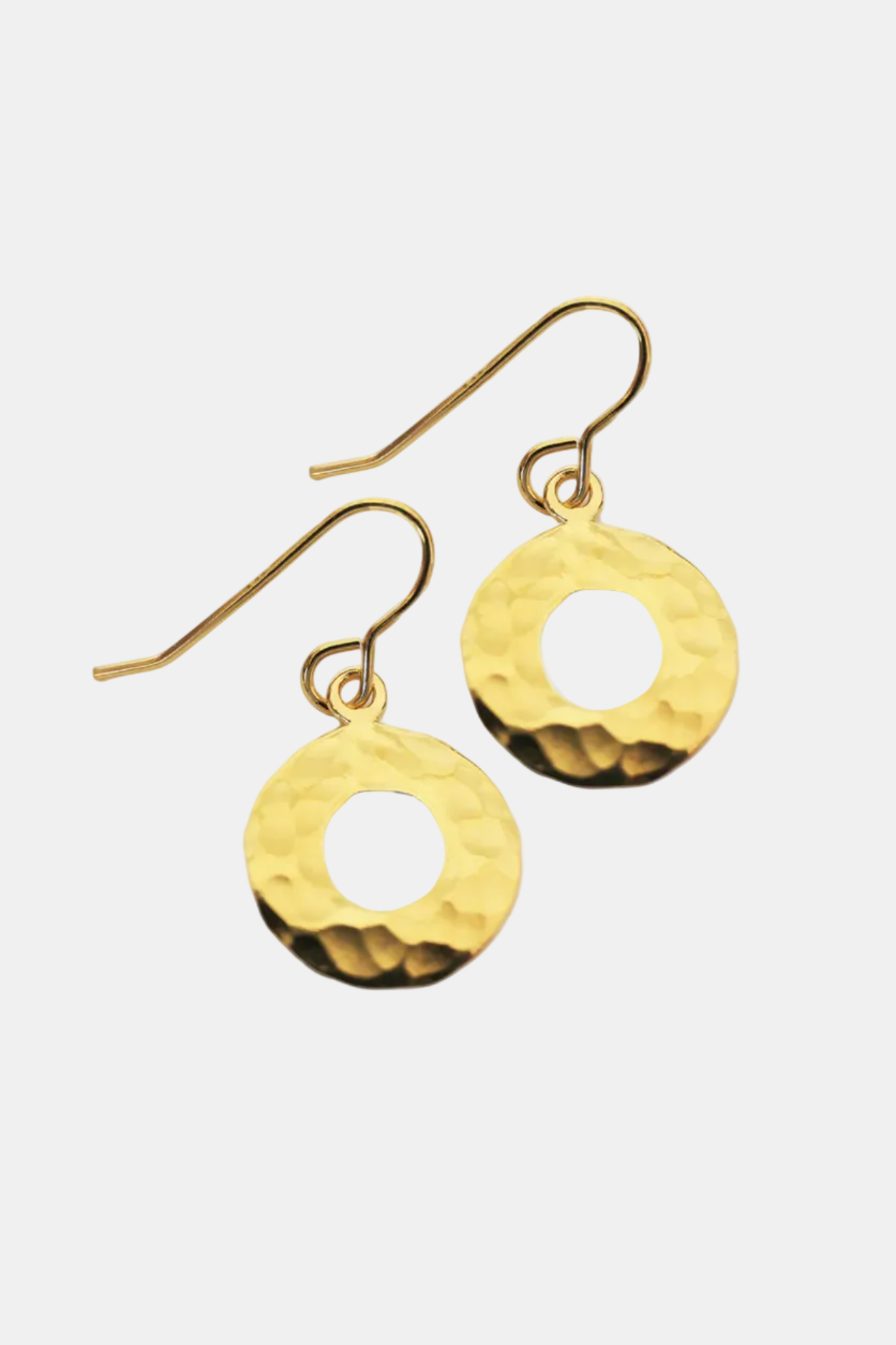 Gold earrings with circular designs on a white background