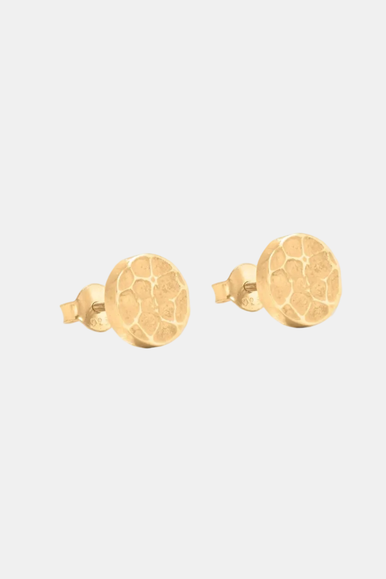 Pair of gold earrings on a white background