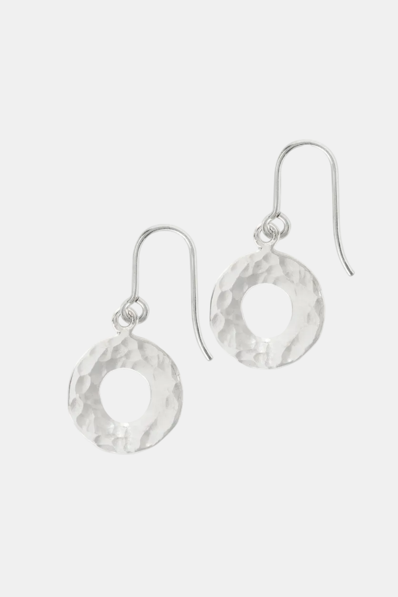 Pair of silver earrings with circular designs on a white background