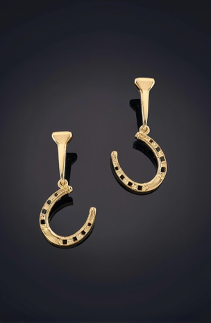 A pair of gold-colored earrings in the shape of horseshoes, with intricate details and a hook at the top for attachment.