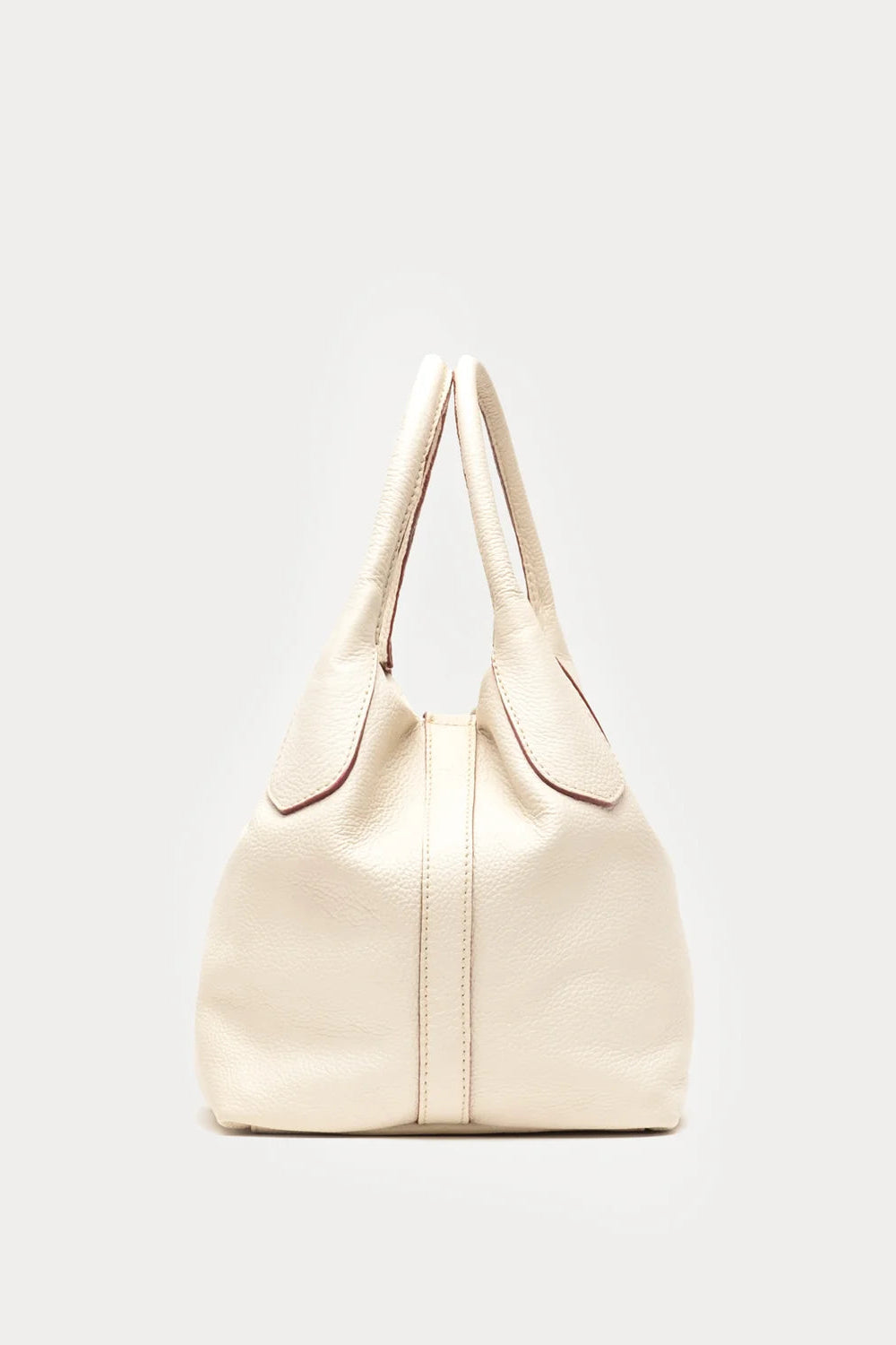 A cream-colored pebbled leather handbag with double top handles and a front flap detail, photographed against a solid light gray background.