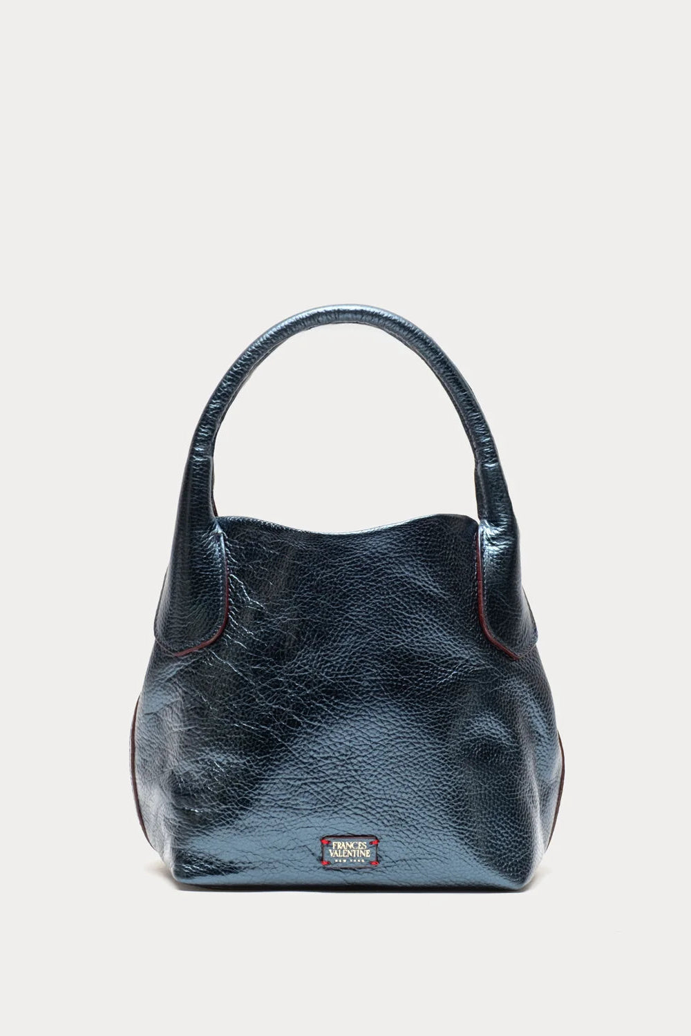 A dark blue textured leather handbag with a single top handle, shown against a plain light gray background.