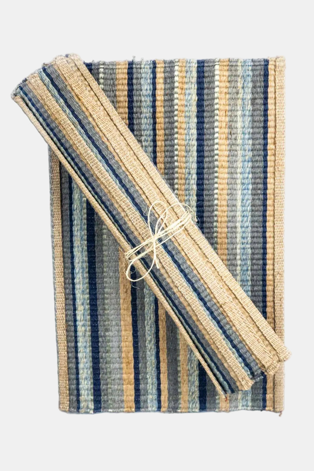 Striped woven mat with a rolled-up straw mat on a white background