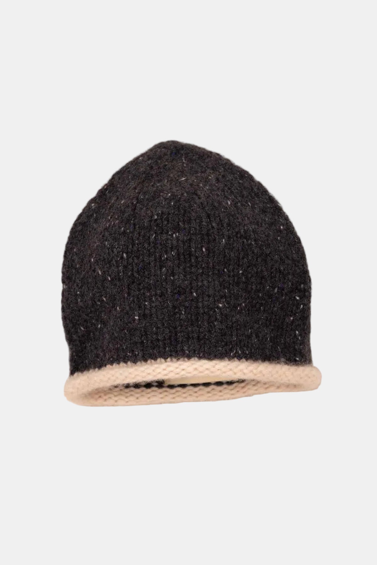 A black knit beanie hat with a contrasting beige ribbed brim, displayed flat against a textured beige fabric background.