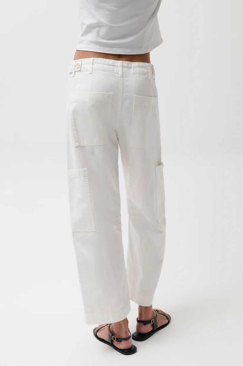 Person wearing white pants and a white shirt on a white background