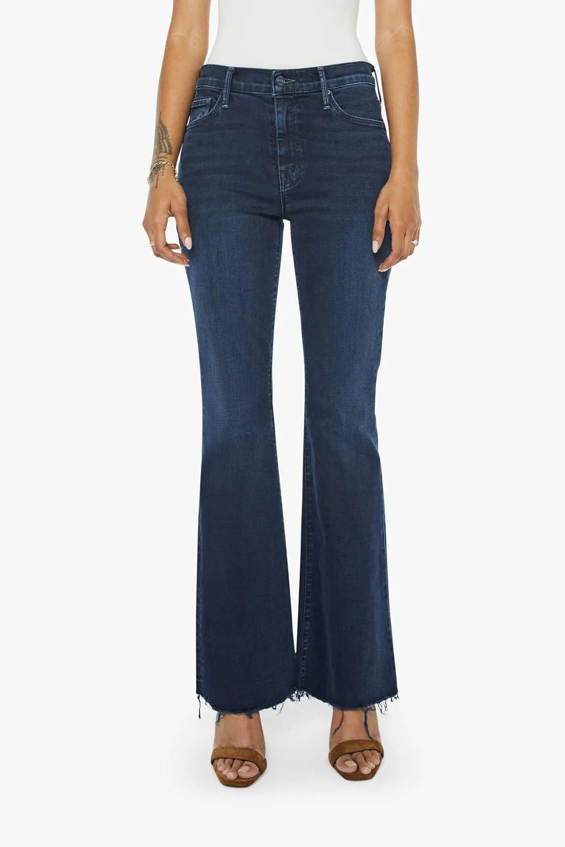 Woman wearing blue jeans and a white top on a white background