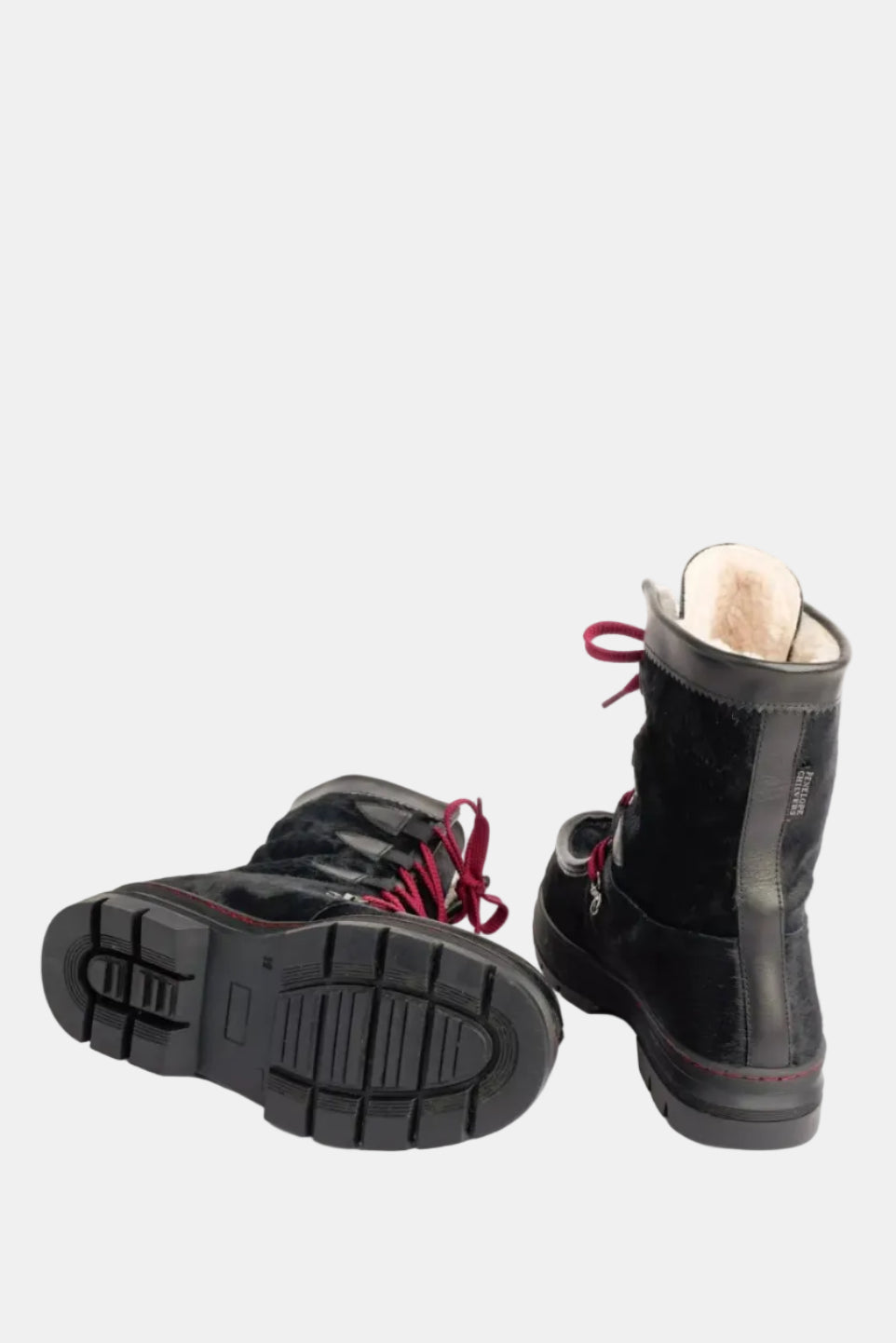 Black winter boots with red laces on a white background