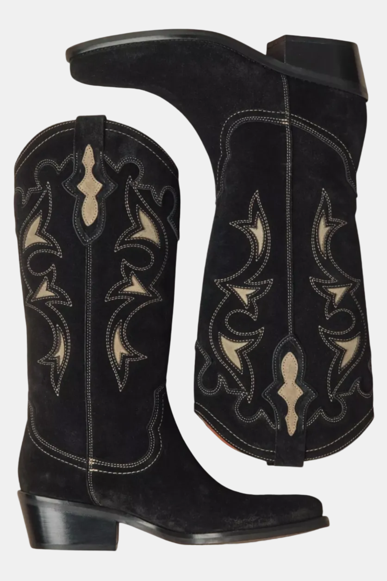 Black cowboy boots with intricate white patterns on a white background