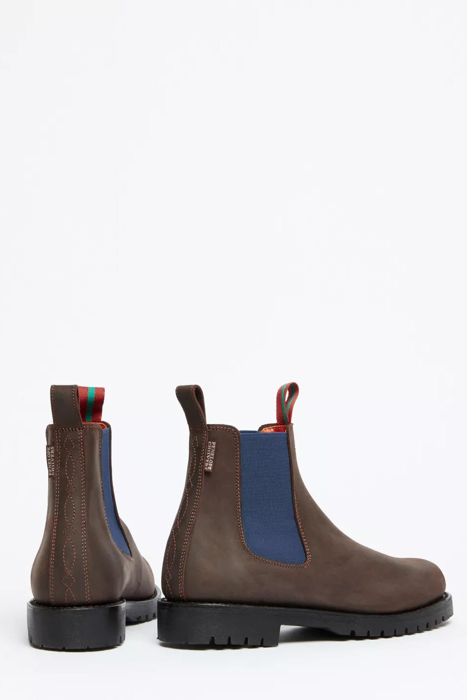 Pair of brown leather boots with blue accents on a white background